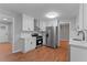 Updated kitchen with white cabinets, stainless steel appliances, hardwood floors, and adjacent dining area at 2002 Twin Falls Rd, Decatur, GA 30032