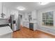 Bright kitchen featuring stainless steel appliances, white cabinetry, and wood-look flooring at 2002 Twin Falls Rd, Decatur, GA 30032