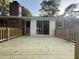 A newly installed back deck with wood railings leading up to a sliding glass door at 2266 Eastgate Dr, Snellville, GA 30078