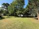 Expansive backyard with mature trees and lush green grass, perfect for outdoor activities at 2266 Eastgate Dr, Snellville, GA 30078