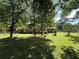 A grassy backyard with mature trees shading the lawn and the home in the background at 2266 Eastgate Dr, Snellville, GA 30078