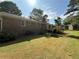 Lovely brick home with a spacious backyard featuring a deck, mature trees, and green grass at 2266 Eastgate Dr, Snellville, GA 30078