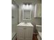 Bathroom featuring a single sink vanity, storage, and a tub shower with glass doors at 2266 Eastgate Dr, Snellville, GA 30078