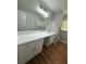 Spacious bathroom featuring a double vanity, modern lighting, and a large mirror at 2266 Eastgate Dr, Snellville, GA 30078