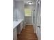 Bathroom featuring a single sink vanity, wood look flooring, and a tub and shower with glass doors at 2266 Eastgate Dr, Snellville, GA 30078