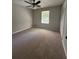 Spacious bedroom with neutral carpet, a ceiling fan, and a closet at 2266 Eastgate Dr, Snellville, GA 30078