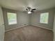 Bedroom featuring neutral paint, carpet flooring, ceiling fan, and two windows for natural light at 2266 Eastgate Dr, Snellville, GA 30078