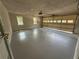 Spacious two car garage with neutral walls, gray floors, and an insulated garage door at 2266 Eastgate Dr, Snellville, GA 30078