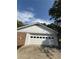 Garage with white door and white siding next to brick under blue skies at 2266 Eastgate Dr, Snellville, GA 30078