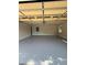Spacious two car garage with neutral walls, gray floors, and an insulated garage door at 2266 Eastgate Dr, Snellville, GA 30078