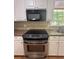 Kitchen features stainless steel oven and black microwave at 2266 Eastgate Dr, Snellville, GA 30078