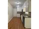 Well-lit kitchen featuring white cabinets, updated appliances, and hardwood floors at 2266 Eastgate Dr, Snellville, GA 30078