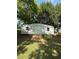 Large storage building with double doors and a wood ramp in a spacious backyard at 2266 Eastgate Dr, Snellville, GA 30078