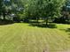 Picturesque backyard features a lush lawn and mature trees at 3551 Skyline Sw Ter, Marietta, GA 30008