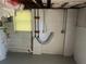 Unfinished basement featuring painted concrete walls and exposed piping near a window at 3551 Skyline Sw Ter, Marietta, GA 30008