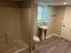 Basement bathroom showcasing a shower, sink, toilet, and window at 3551 Skyline Sw Ter, Marietta, GA 30008