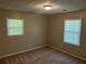Bright bedroom with neutral walls, cozy carpeting, and natural light from dual windows at 3551 Skyline Sw Ter, Marietta, GA 30008