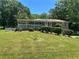 Charming home featuring brick facade, covered porch, and landscaped front yard at 3551 Skyline Sw Ter, Marietta, GA 30008
