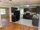 Functional kitchen with dark cabinetry, black appliances, and tile flooring at 3551 Skyline Sw Ter, Marietta, GA 30008