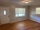 Inviting living room with hardwood floors and ample natural light from the large window at 3551 Skyline Sw Ter, Marietta, GA 30008