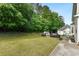 A spacious backyard with a greenhouse, patio furniture and lots of trees at 4630 Smokestone Dr, Douglasville, GA 30135
