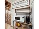 Basement nook with a 'Gathering Place' sign, microwave, Keurig, and decorative pumpkins at 4630 Smokestone Dr, Douglasville, GA 30135