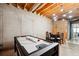Finished basement with an air hockey table, dining area, and exposed ceiling at 4630 Smokestone Dr, Douglasville, GA 30135