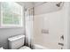 Bathroom featuring a toilet and tiled shower next to a window at 4630 Smokestone Dr, Douglasville, GA 30135