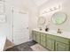 Bright bathroom featuring a double sink vanity with updated fixtures and dual mirrors at 4630 Smokestone Dr, Douglasville, GA 30135
