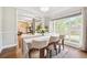 Bright dining room with large window, elegant table setting, and hardwood floors at 4630 Smokestone Dr, Douglasville, GA 30135