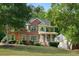 Two-story brick home features manicured lawn, charming green shutters, and natural surroundings at 4630 Smokestone Dr, Douglasville, GA 30135