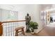 Bright hallway featuring stylish decor, wood railing, natural light, and carpeted floors at 4630 Smokestone Dr, Douglasville, GA 30135