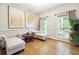 Elegant sitting room featuring hardwood floors, tufted furniture, and large windows at 4630 Smokestone Dr, Douglasville, GA 30135