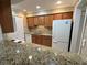 Well-equipped kitchen with granite countertops, wooden cabinets and modern appliances at 1503 Wingate Way # 1503, Sandy Springs, GA 30350