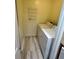 Bright laundry room with woodgrain floors, shelving and a washer and dryer at 1503 Wingate Way # 1503, Sandy Springs, GA 30350