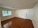 Well-lit living room with hardwood floors and neutral walls, offering a versatile space for relaxation and entertainment at 1503 Wingate Way # 1503, Sandy Springs, GA 30350