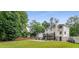 Large backyard has an in-ground pool, wooden fence, and mature trees at 1560 Boxwood Nw Trce, Acworth, GA 30102