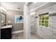 Bright bathroom with a modern vanity, stylish lighting, and walk-in glass shower with gray accent tile at 1560 Boxwood Nw Trce, Acworth, GA 30102