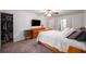 Bright bedroom with a wooden dresser, TV, ceiling fan, and convenient access to the bathroom and closet at 1560 Boxwood Nw Trce, Acworth, GA 30102