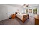 Bright bedroom with neutral carpet, ceiling fan, and two windows at 1560 Boxwood Nw Trce, Acworth, GA 30102