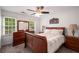 Well-lit bedroom featuring neutral walls, plush carpeting, ceiling fan, and wood furniture at 1560 Boxwood Nw Trce, Acworth, GA 30102