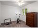 Simple bedroom offering ample light with a window, a neutral wall and carpeting, and dresser at 1560 Boxwood Nw Trce, Acworth, GA 30102