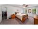 Cozy bedroom with a wood bed frame, neutral walls, plush carpeting, and bright natural light at 1560 Boxwood Nw Trce, Acworth, GA 30102