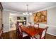 Spacious dining room with wooden table and view into adjacent kitchen at 1560 Boxwood Nw Trce, Acworth, GA 30102
