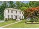 Charming two-story home with a brick facade, mature trees, and a well-manicured lawn at 1560 Boxwood Nw Trce, Acworth, GA 30102