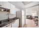 Kitchenette with white appliances and cabinets with tile flooring at 1560 Boxwood Nw Trce, Acworth, GA 30102