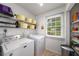 Bright laundry room with shelving, organizing bins, and washer/dryer at 1560 Boxwood Nw Trce, Acworth, GA 30102