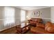Cozy living room featuring hardwood floors, comfortable seating, and natural light at 1560 Boxwood Nw Trce, Acworth, GA 30102