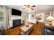 Living room featuring hardwood floors, fireplace, and access to the backyard at 1560 Boxwood Nw Trce, Acworth, GA 30102