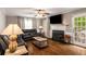 Relaxing living room with hardwood floors, fireplace, and access to the outdoor space at 1560 Boxwood Nw Trce, Acworth, GA 30102